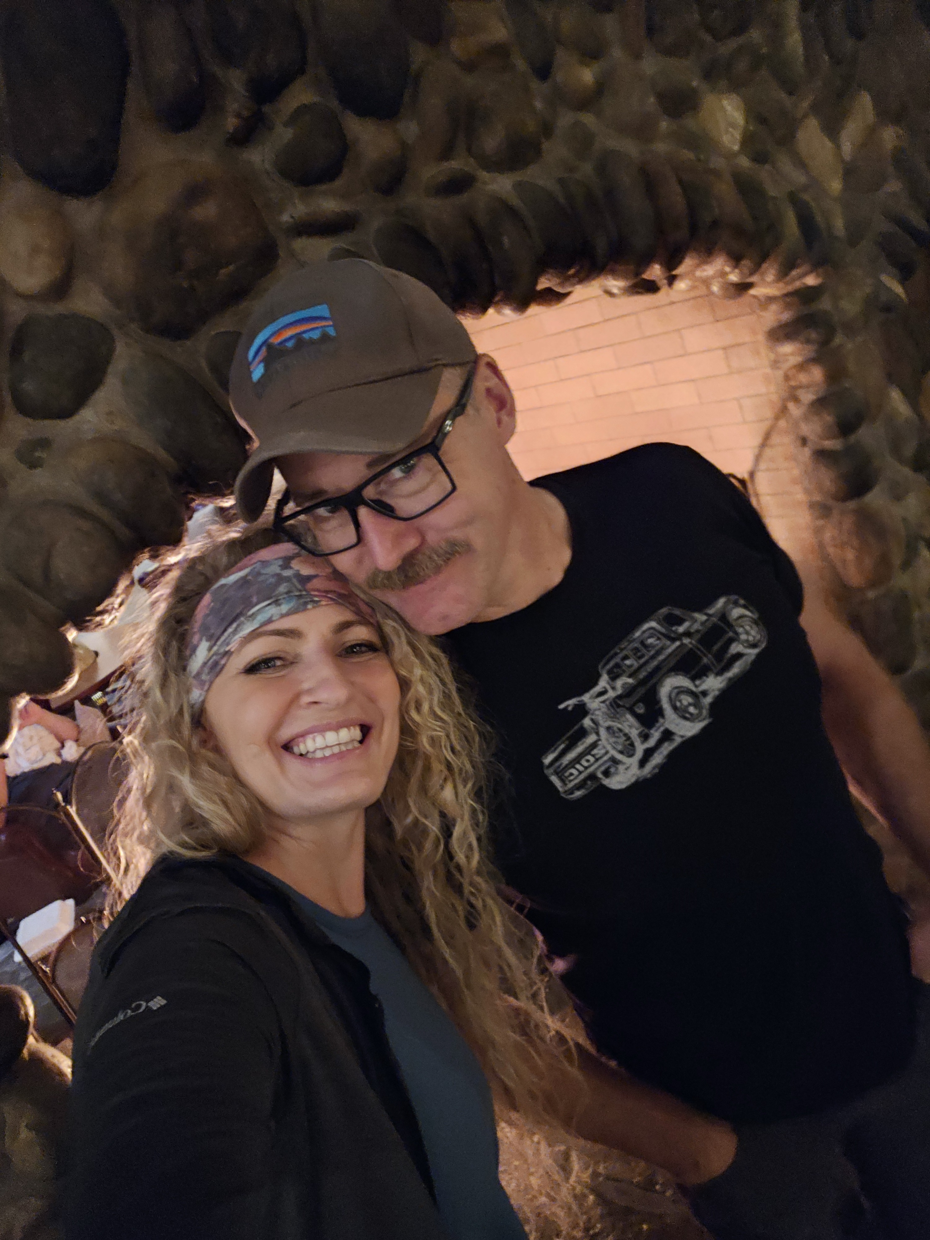 DrWebberposeswithherhusbandunderarockarch