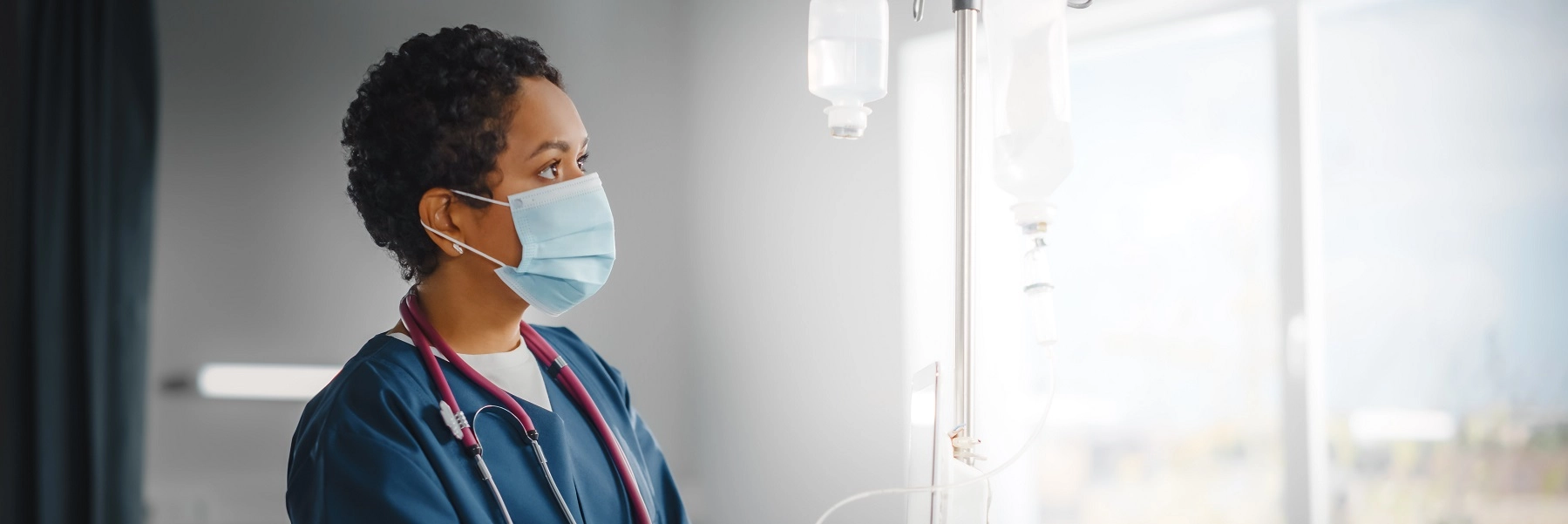 AnAfricanAmericanfemalenursefillsanIVbag