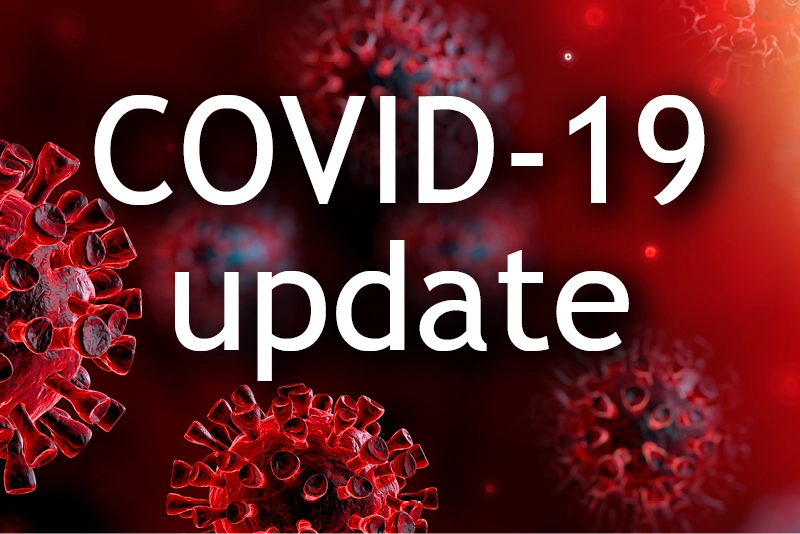 A graphic reading "COVID-19 update" with red germs in the background.