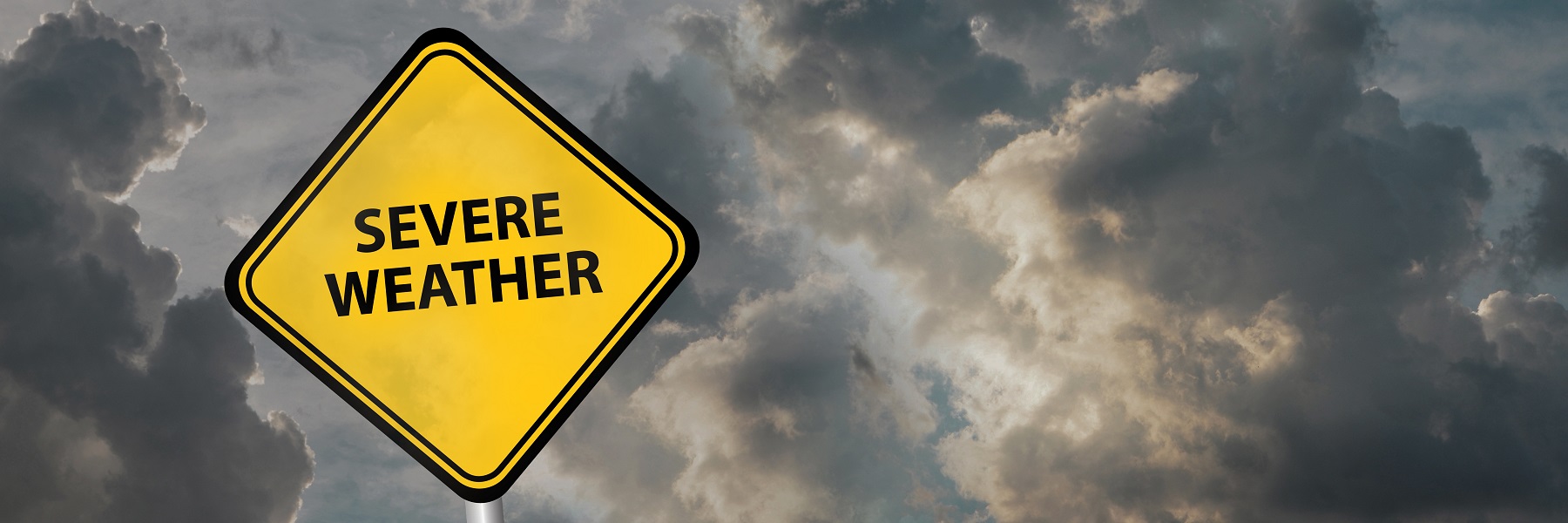 Ayellowsevereweatherroadsignonabackgroundofdarkclouds