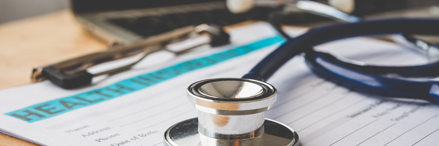 Stethoscopeonadeskwithmedicalpaperwork