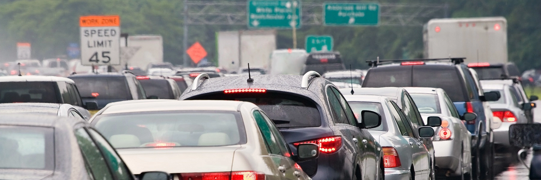 Atrafficjamofcarsandtrucksonarainyday