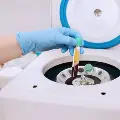 Techniciantakesbloodoutofacentrifuge