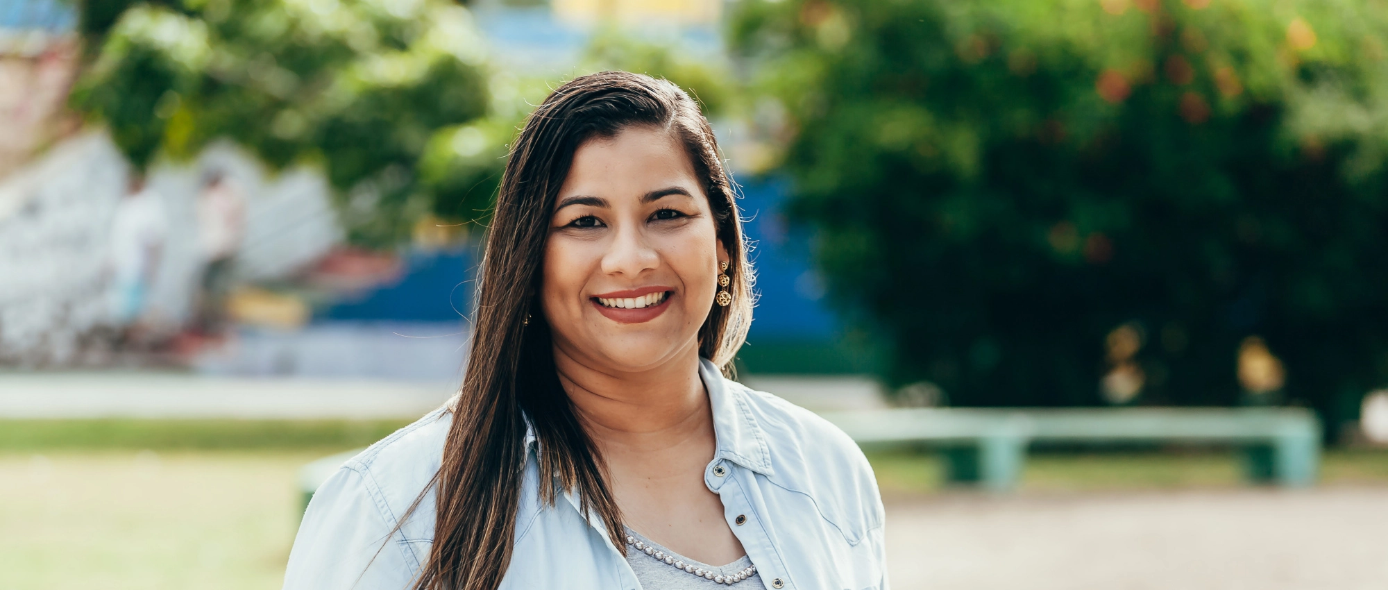 Womanstandingoutsideandsmilingatthecamera