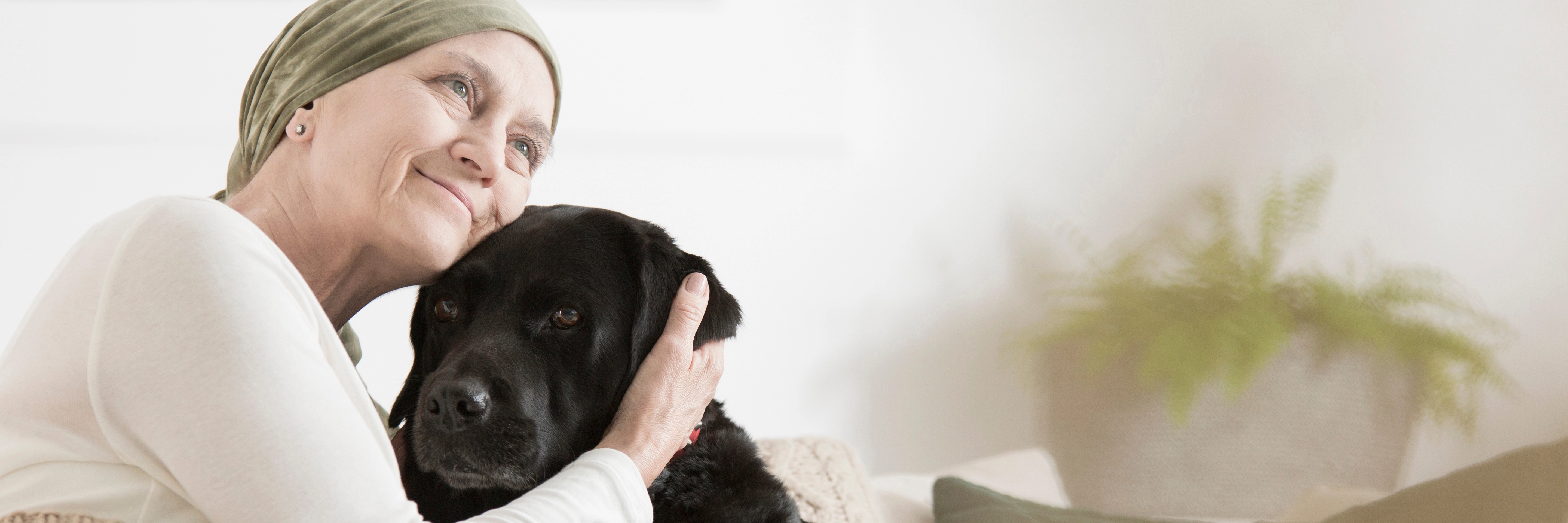 Smilingwomanwearingheadscarfposingwithadog