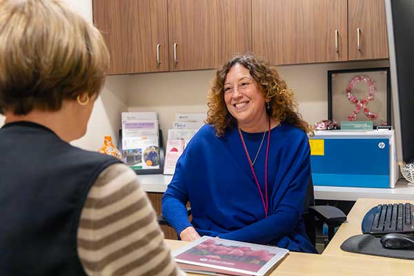 A nurse navigator meeting with a patient