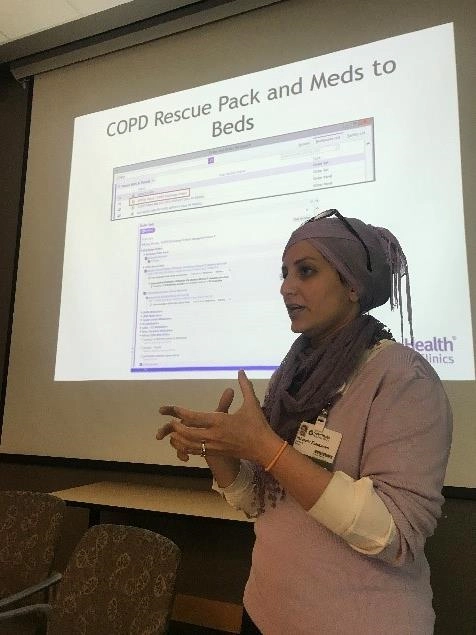 AwomanstandingbyascreendisplayingaCOPDrescueslide