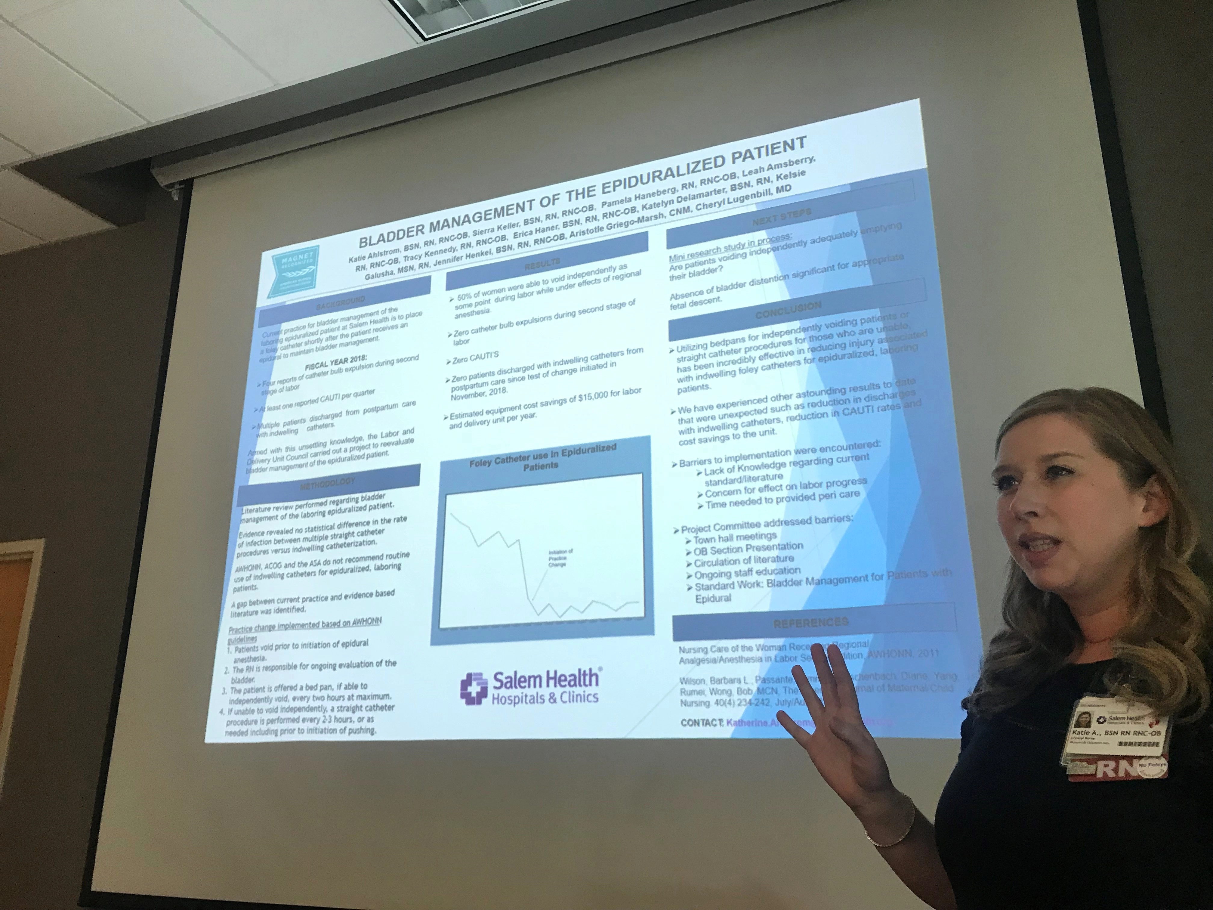 Awomanstandingbyascreendisplayingandepiduralbladderslide