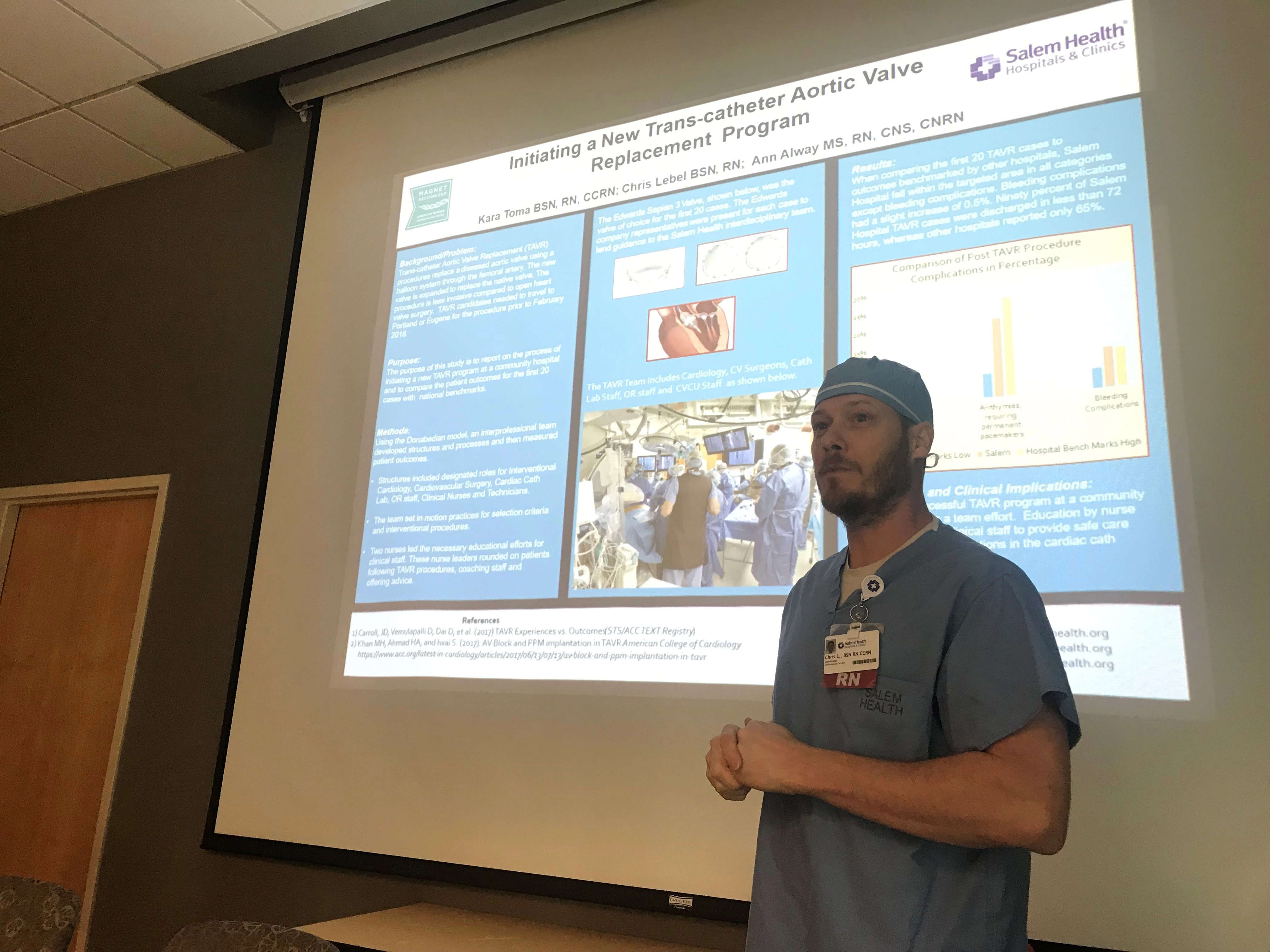 AmanstandingbyascreendisplayingaTAVRslide