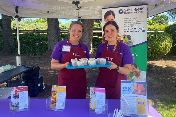 TwoSalemHealthstafferssmilingatacommunityevent