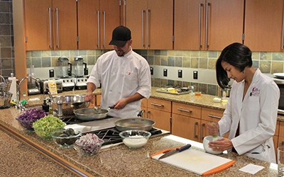 Two people preparing food in the CHEC Kitchen