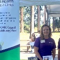 TwoSalemHealthCHECstaffersstandingbehindinfotableatcommunityevent