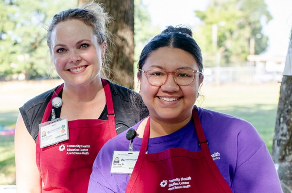 TwoSalemHealthCHECstafferssmilingatcommunityevent