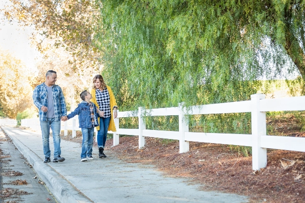 Familyhappilywalkingonasidewalk