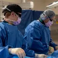 Cathlabsurgeonsdoingaprocedureonapatient