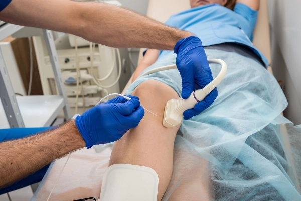 Vascular tech performing a vascular ultrasound on a patient's leg