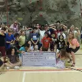 CommunityRelationsgiantcheckpresentationtoBoysandGirlsClub2022-kidsinfrontofrockclimbingwall