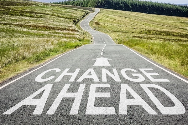 Illustration of a change ahead sign on the road disappearing into the distance