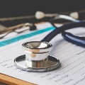 Stethoscopelayingontopofmedicalpaperwork