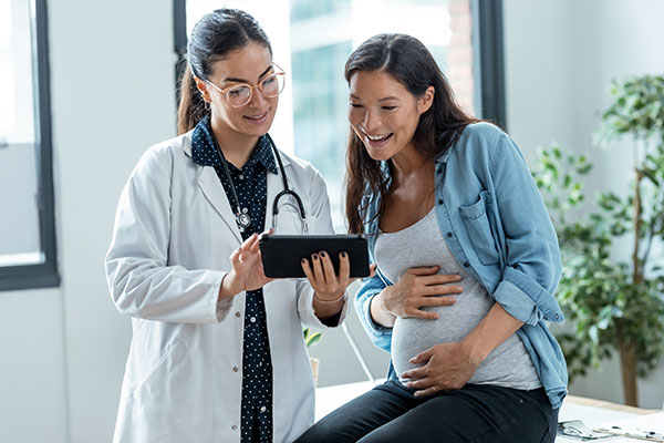 Excited pregnant woman with doctor