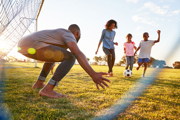 Family playing soccer