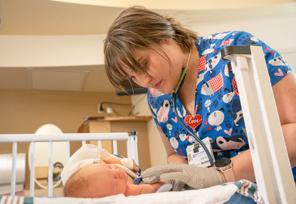 Nurse taking care of newborn
