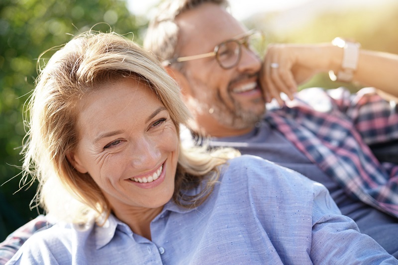 Middle-aged couple lounging outdoors