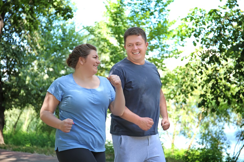 Man and woman jogging together at the park