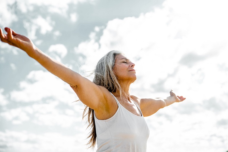 joyful mature woman basking in the sun