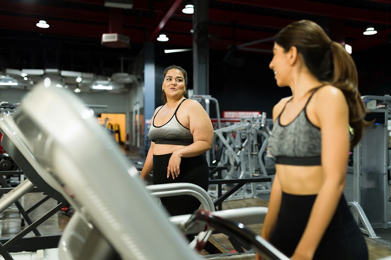 Women of different sizes working out at a gym