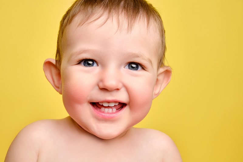 Happy toddler baby boy with ears that stick out