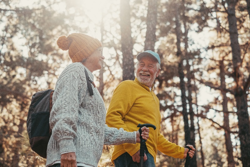 Middle aged woman hiking with her husband enjoying free time and nature.