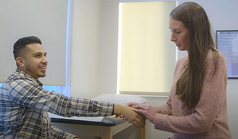 DrMitchellexaminingapatientshand