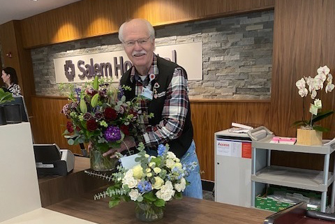A volunteer delivers flowers
