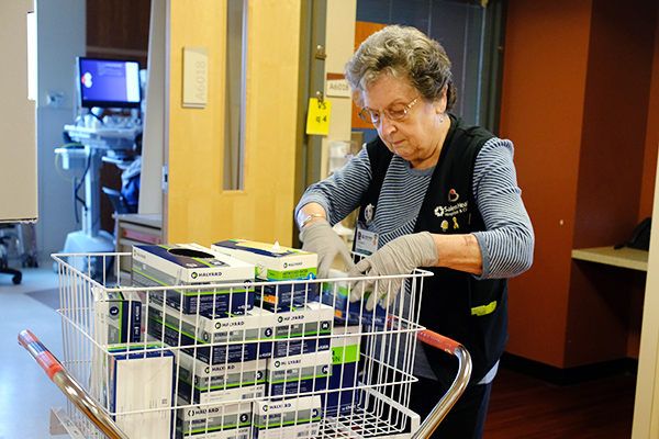 Volunteer restocks supplies