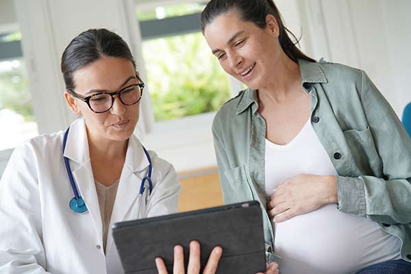Pregnant woman with her doctor