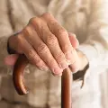 Elderlyhandsrestingonacane