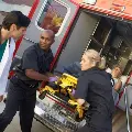 SurgeonrushestoambulanceastwoEMTsunloadapatientonastretcher