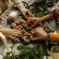 Familyenjoyingholidayappetizersandwineatfestivetablesetting