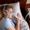 Youngfemalesleepingwithcpapmachineforsleepapnea