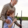 Oldermantakinghisgrandsonfishing