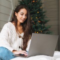 Youngwomanworkingonalaptopatchristmastime