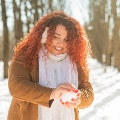 Womanmakingasnowballinthewoods