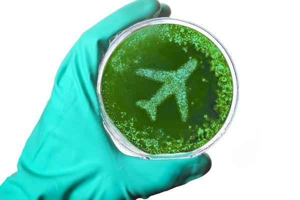 Aglowedhandholdingapetridishwithgreengoointheshapeofaplane