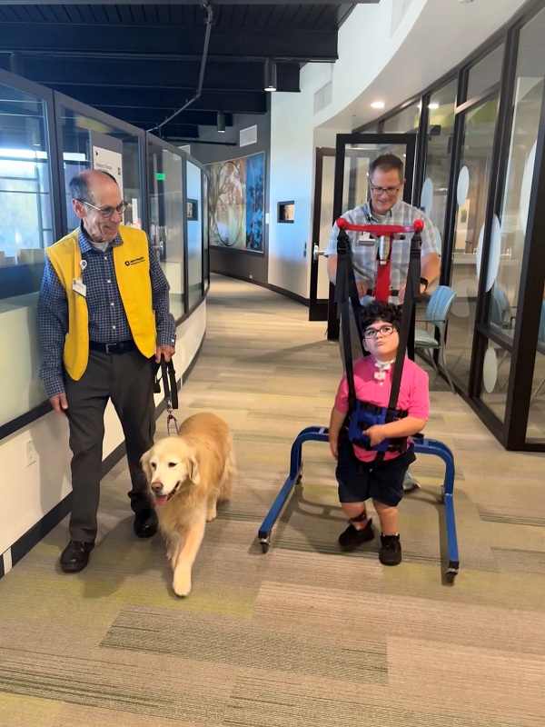 Eric Schuman and Kimber walk with Axel and PT Trent Tompkins