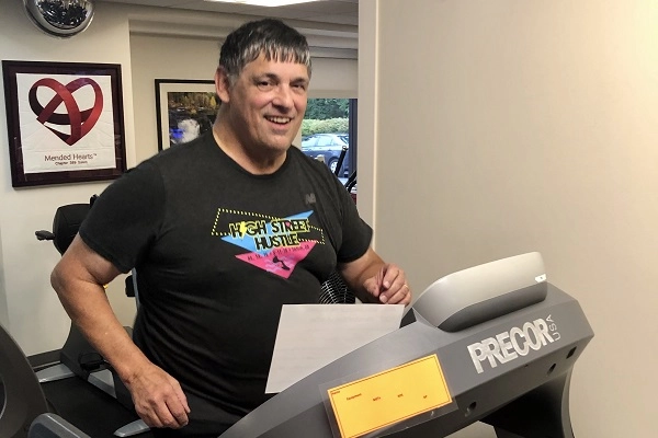 Nathan wears a High Street Hustle tee as he works out on a treadmill.