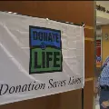 manadjustsDonateLifeorgandonationflaginthelobbyofBuildingA