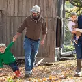 Familywithsmallkidsplayingintheleaves