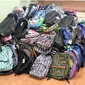 Room-sizepileofbackpacksfortheSalemHealthbackpackdrive