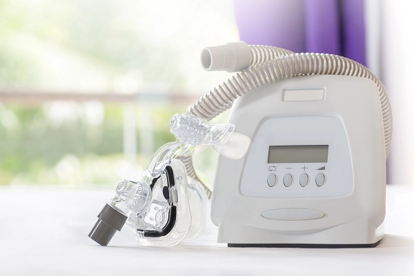 testimonial-sleep-william CPAP machine at side of bed.